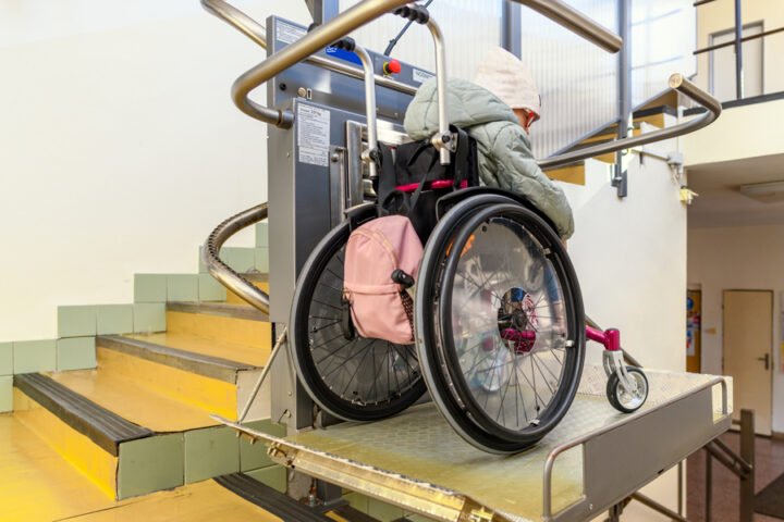 Woman in a wheelchair riding Stair Chair Lift after Installation in Princeton, WV